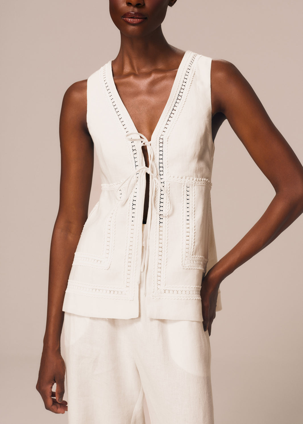Detalhe da blusa com amarração frontal na cor off White Essência La Gea