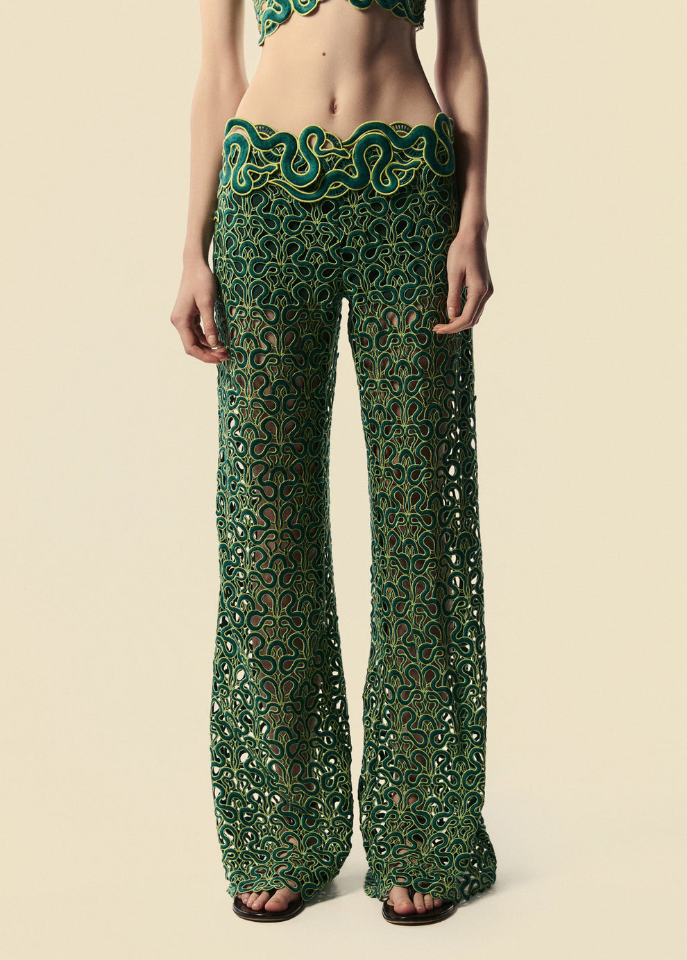 Modelo de frente com detalhe do caimento e cós da calça flare Trilhas da coleção de Verão 27.